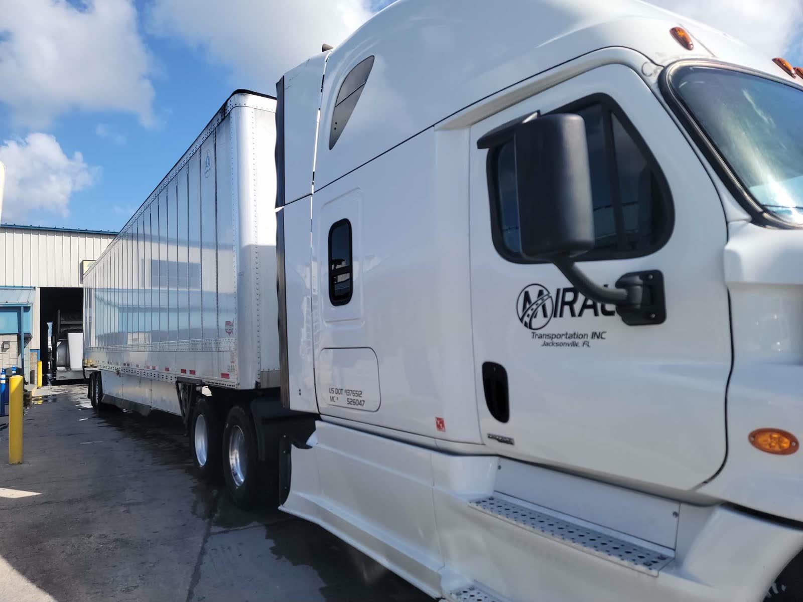 Miral Transportation logo and USDOT number on a white Cascadia door